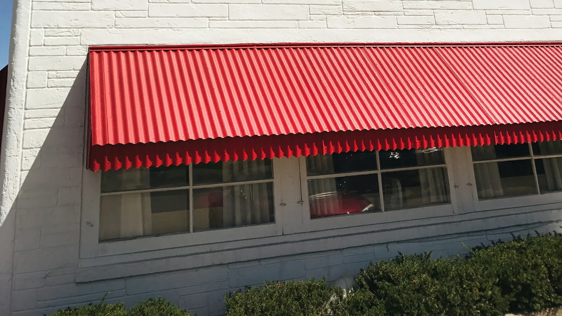 A fabric awning shading the front of a store.